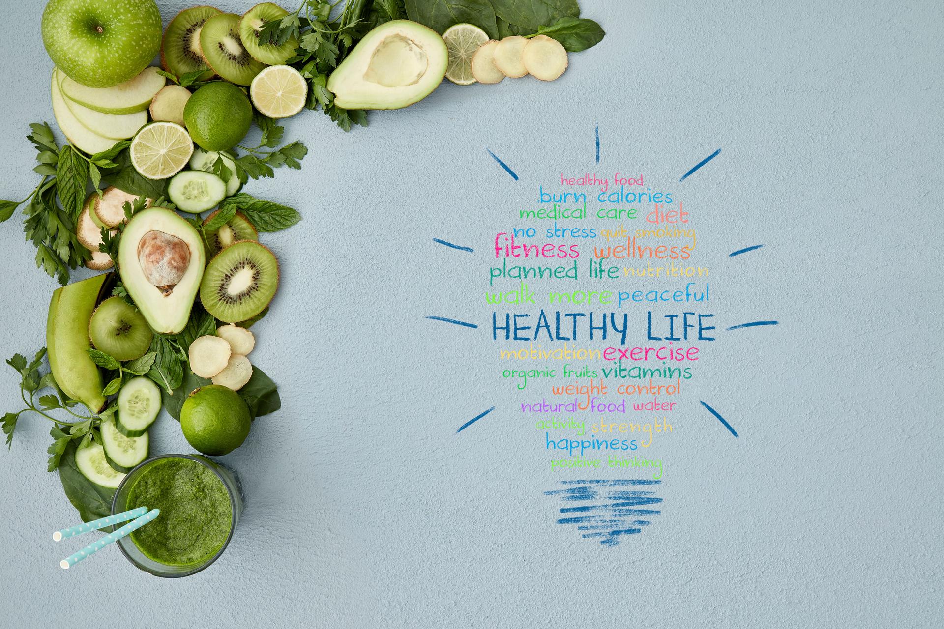 Healthy life words on table with smoothie and vegetable